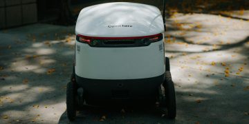 Autonomous delivery robot in urban setting, showcasing modern technology.