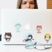 GitHub 스티커가 붙은 노트북 앞 안경 — GitHub Copilot 토큰 종량제