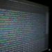 Close-up of colorful programming code on a blurred computer monitor.