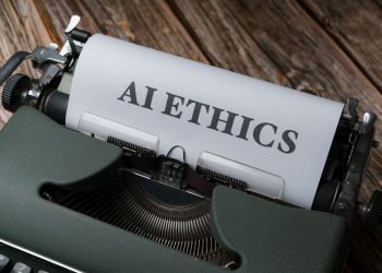 Retro typewriter with 'AI Ethics' on paper, conveying technology themes.