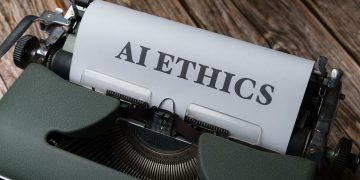 Retro typewriter with 'AI Ethics' on paper, conveying technology themes.