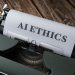 Retro typewriter with 'AI Ethics' on paper, conveying technology themes.