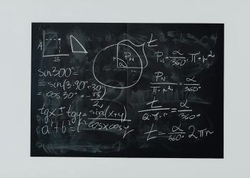 Detailed view of mathematical equations and diagrams on a blackboard.