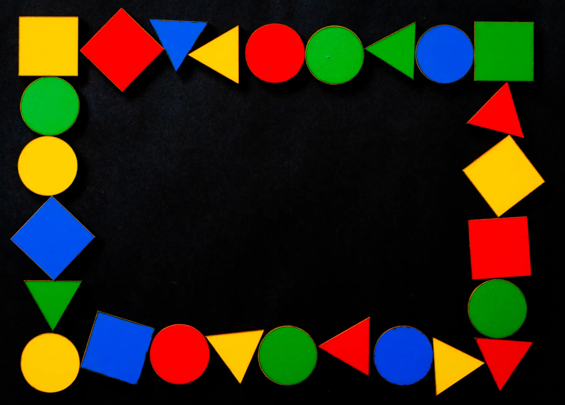 Vibrant geometric shapes create a dynamic frame on a black surface.