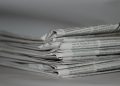 A close-up image of folded newspapers, perfect for news or journalism themes.