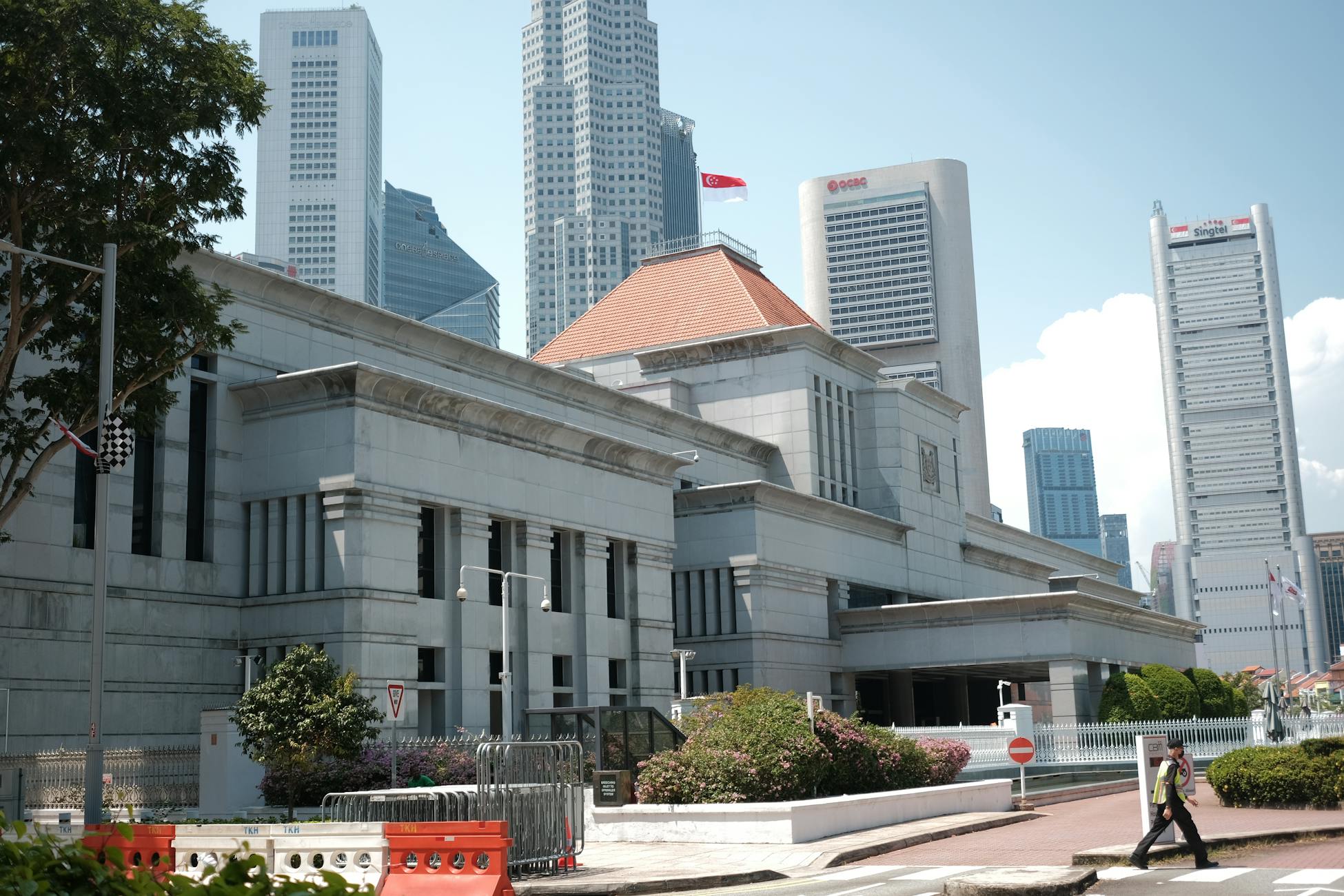 A view of Singapore's urban landscape featuring iconic skyscrapers and a prominent building under a clear sky.
