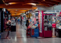 Busy indoor electronics market with modern design and engaged shoppers.