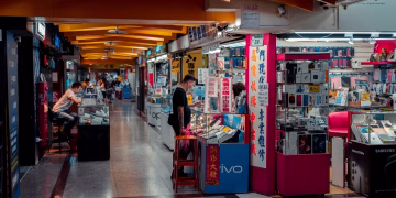 Busy indoor electronics market with modern design and engaged shoppers.