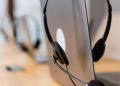 Close-up of a headset resting on a laptop, symbolizing efficient work environment technology.