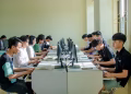 A group of students in a classroom focused on computer screens, fostering digital education.