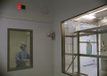Image of a cleanroom in a medical facility featuring sterile equipment and a person in protective clothing.