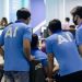 man in blue nike crew neck t-shirt standing beside man in blue crew neck t