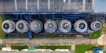 Drone view of industrial terrain with treatment plants located in suburban area in sunlight