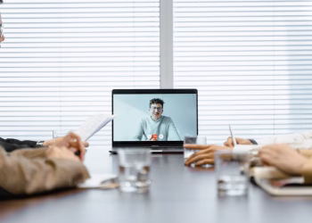 A diverse group participates in a virtual meeting using modern technology.