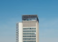 Minimalist shot of a modern high-rise building with clear blue sky background
