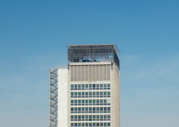 Minimalist shot of a modern high-rise building with clear blue sky background