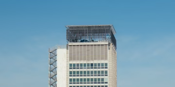 Minimalist shot of a modern high-rise building with clear blue sky background