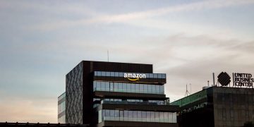 Contemporary architecture showcasing Amazon office at dusk in Iași, Romania.