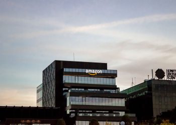 Contemporary architecture showcasing Amazon office at dusk in Iași, Romania.