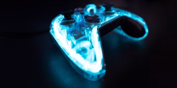 Illuminated gaming controller with blue lights on a dark background, perfect for gaming themes.