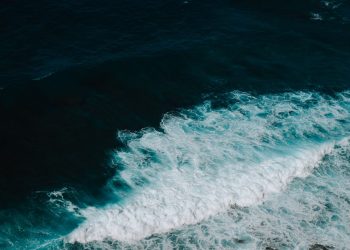 Stunning high-angle view of ocean waves crashing, showcasing nature's powerful beauty.