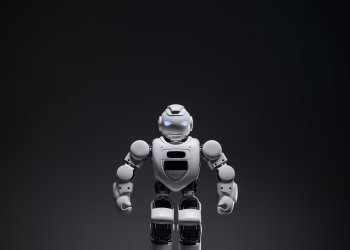 Close-up of a white toy robot with glowing eyes in a studio setting.