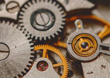A detailed macro shot of metal gears and cogs showcasing engineering precision and mechanical art.