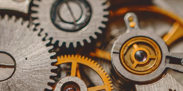 A detailed macro shot of metal gears and cogs showcasing engineering precision and mechanical art.