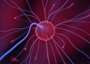 Close-up of a glowing plasma ball with colorful electric currents reaching outwards.