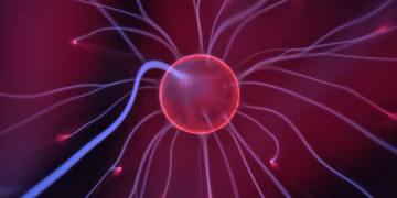 Close-up of a glowing plasma ball with colorful electric currents reaching outwards.