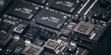 Detailed close-up of electronic microchips on a circuit board, showcasing technology and engineering intricacies.