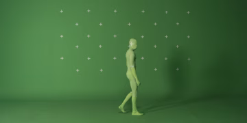 Person walking in a chroma key suit in a studio with green screen for video editing.
