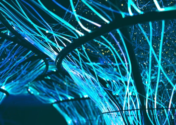 A mesmerizing display of glowing neon blue optical fibers creating a futuristic atmosphere.