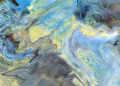 Colorful abstract swirl featuring blue and yellow tones, creating a dynamic and vibrant pattern.