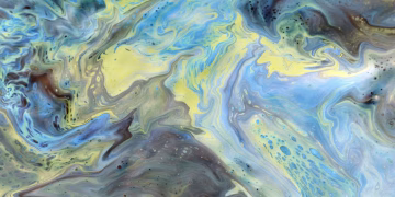 Colorful abstract swirl featuring blue and yellow tones, creating a dynamic and vibrant pattern.