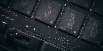 Detailed shot of microchips on a circuit board, showcasing electronic technology and precision engineering.