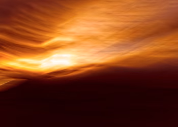 Abstract image capturing the vivid hues of a sunset with motion blur effect.