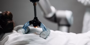 Close-up of a robotic massage arm applying therapy on a person, showcasing innovation.