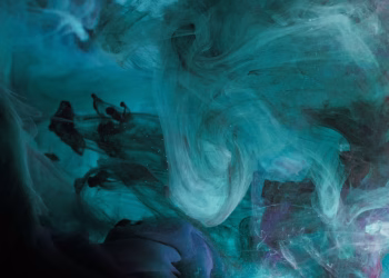 A mesmerizing abstract ink swirl in deep blue tones, creating a fluid and dynamic underwater texture.