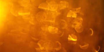 Warm abstract bokeh with vibrant orange and yellow hues, perfect for backgrounds.