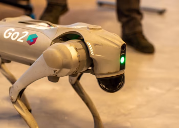 A robotic dog with 'Go2' branding, captured indoors, showcasing modern technology.