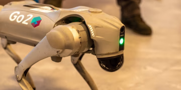 A robotic dog with 'Go2' branding, captured indoors, showcasing modern technology.