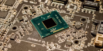 Detailed view of a microchip on a printed circuit board, showcasing electronic components.