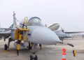 Close-up view of a fighter jet parked at an airport during the day.