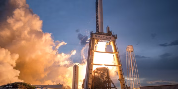 A dramatic shot of a SpaceX rocket launch against a colorful dusk sky, depicting power and technology.