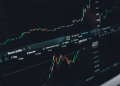 Close-up of a digital market analysis display showing Bitcoin and cryptocurrency price trends.