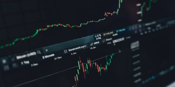 Close-up of a digital market analysis display showing Bitcoin and cryptocurrency price trends.