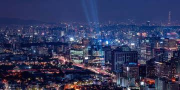 A breathtaking aerial view of a vibrant city illuminated at night.