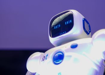 A modern humanoid robot with digital face and luminescent screen, symbolizing innovation in technology.