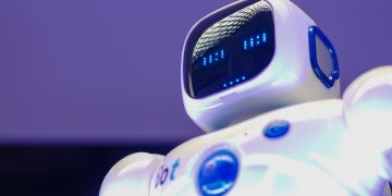 A modern humanoid robot with digital face and luminescent screen, symbolizing innovation in technology.